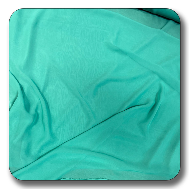 Soft polyester chiffon fabric in vibrant turquoise, perfect for versatile sewing projects.