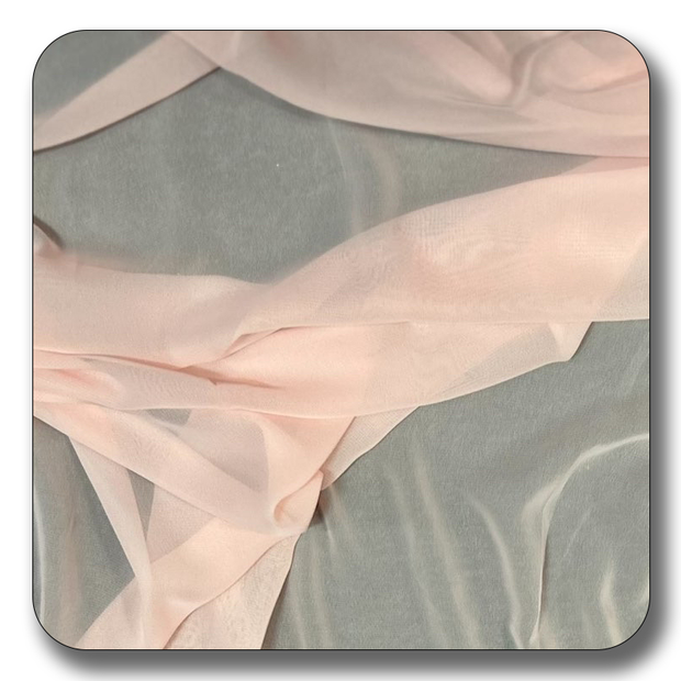 Soft pink polyester chiffon fabric on a gray background, lightweight and durable, sold by the yard.