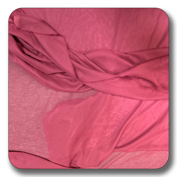 Soft pink chiffon fabric made of 100% polyester, lightweight and durable, ideal for various sewing projects.