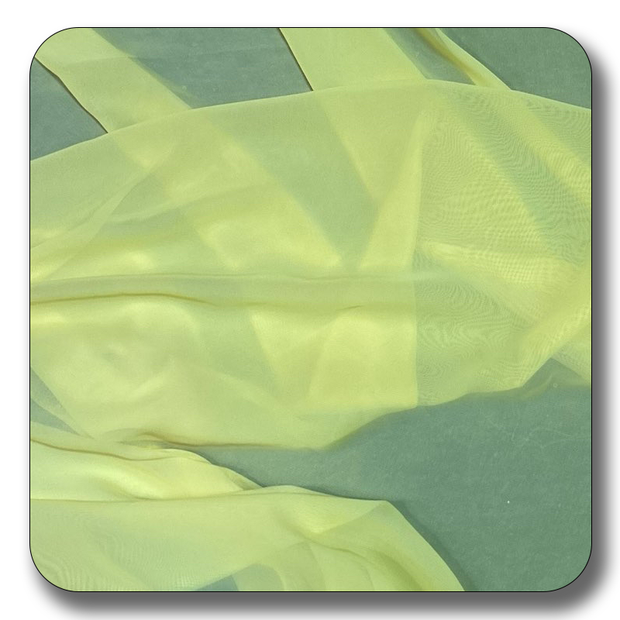 Soft yellow polyester chiffon fabric draped on a surface, showcasing its lightweight and translucent quality.