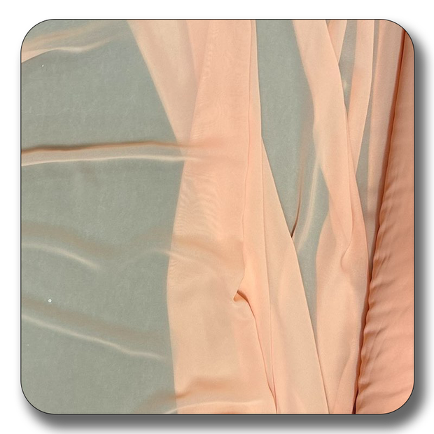 Soft polyester chiffon fabric in a light peach color, showing its lightweight and sheer texture.