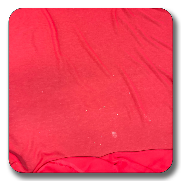 Close-up of soft red polyester chiffon fabric, showcasing its lightweight and durable texture.