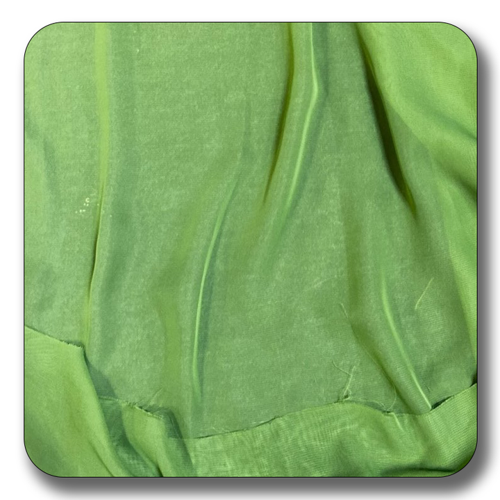 Close-up of soft green polyester chiffon fabric showcasing its lightweight and elastic texture.
