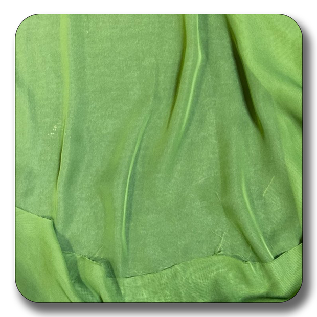 Close-up of soft green polyester chiffon fabric showcasing its lightweight and elastic texture.