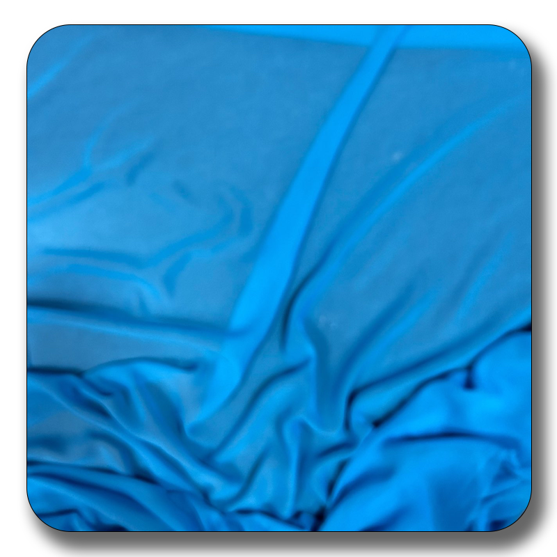 Close-up of blue polyester chiffon fabric showcasing its soft, durable texture and elegant drape, perfect for various sewing projects.