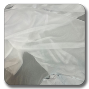 Soft white polyester chiffon fabric draped elegantly, lightweight and versatile for various uses.