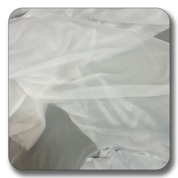 Soft white polyester chiffon fabric draped elegantly, lightweight and versatile for various uses.