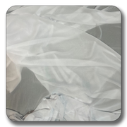 Soft white chiffon fabric draped elegantly, showcasing its lightweight and translucent quality, ideal for various sewing projects.