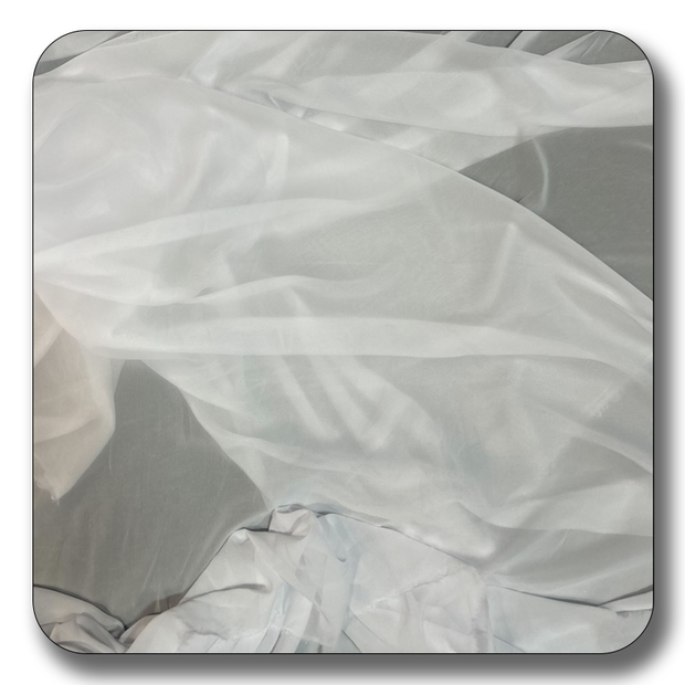 Soft white chiffon fabric draped elegantly, showcasing its lightweight and translucent quality, ideal for various sewing projects.
